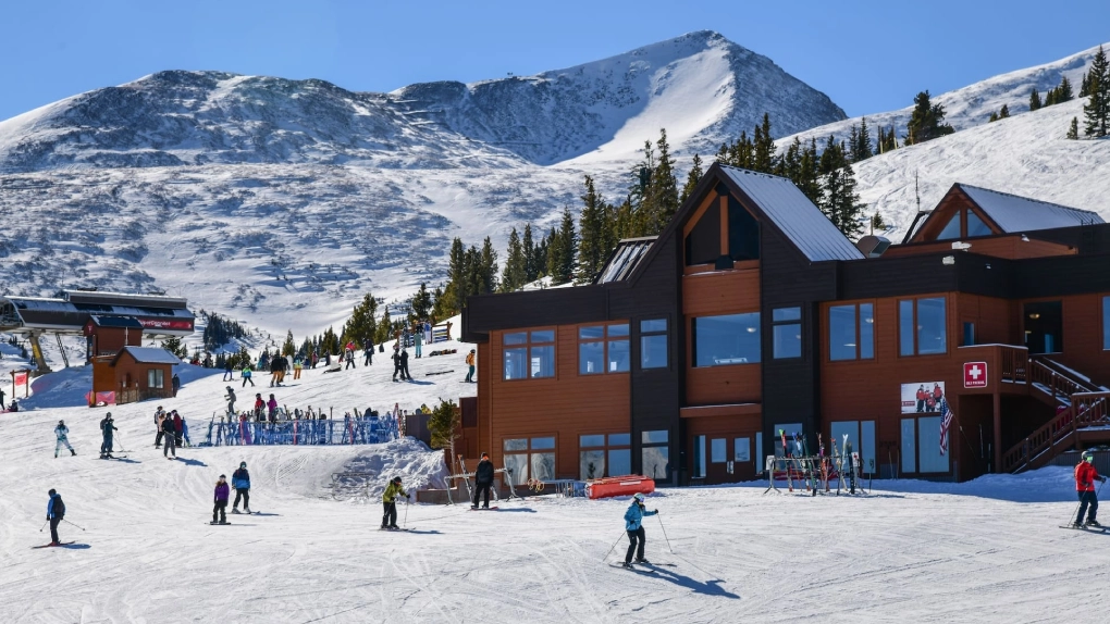 Luxury black car arriving in Breckenridge surrounded by Colorado mountains